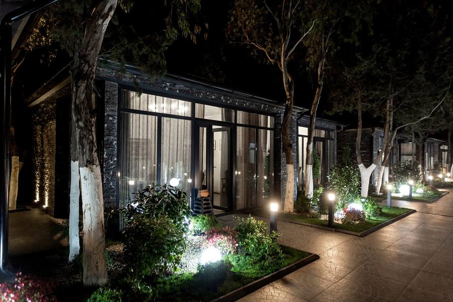 Garden path and cottage lit up at night