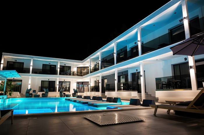 Villa lit up at night by the pool