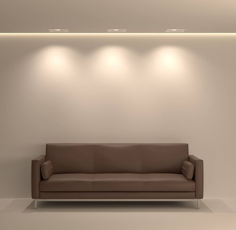 Warm dimmed lighting above a leather sofa