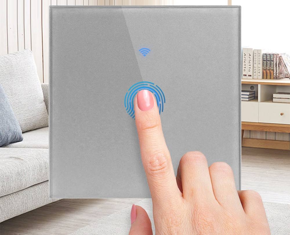 Finger touching a capacitive smart wall switch in a modern living room